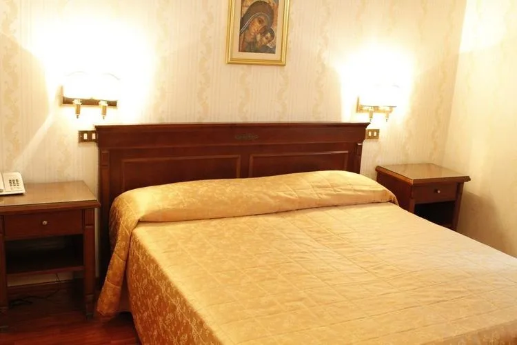 Representative hotel space: A bedroom with a bed and matching bedside tables.