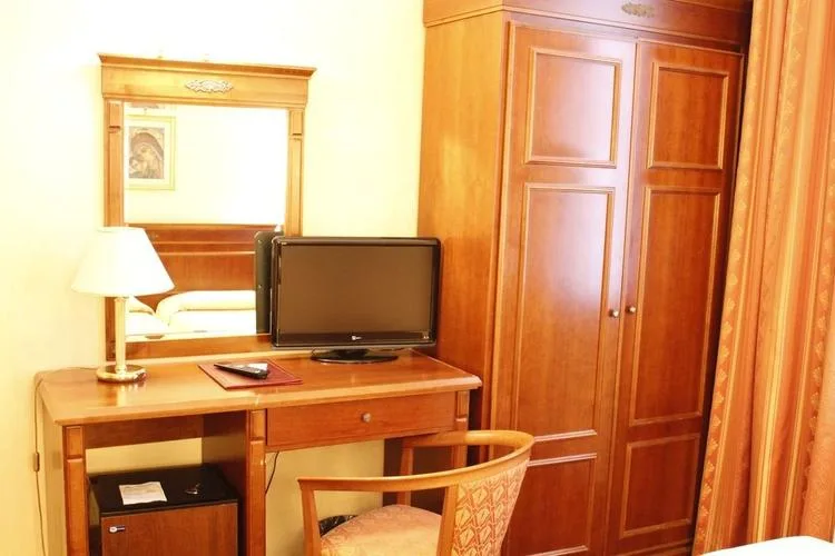 Representative hotel space: A hotel bedroom workspace with a television, desk, and wardrobe.