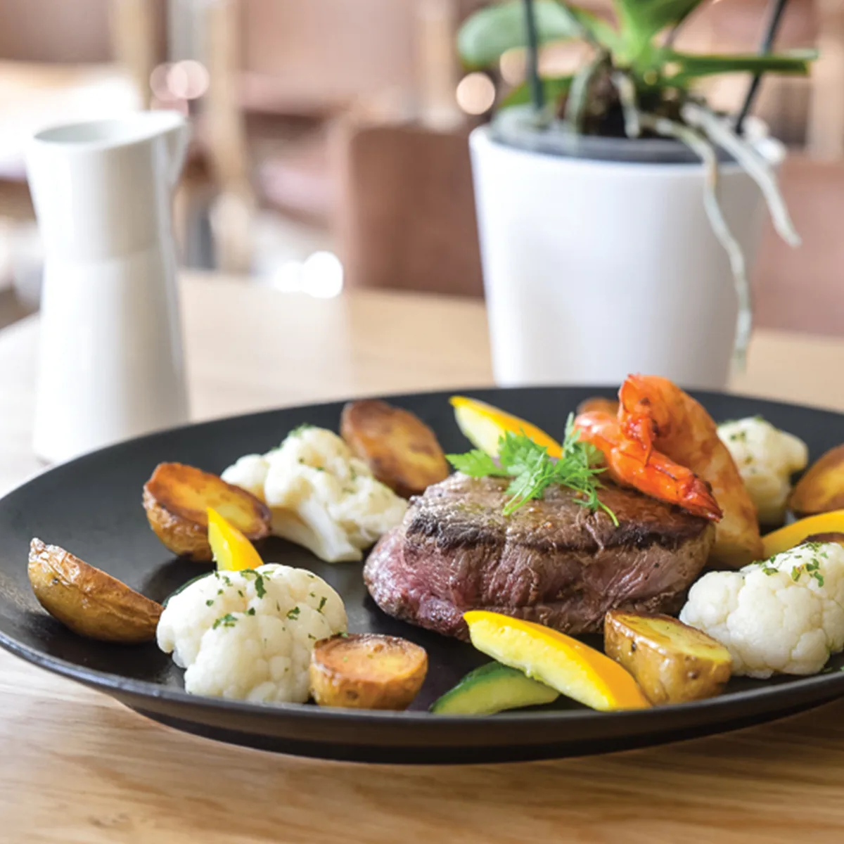 Representative hotel space: A plated steak meal with vegetables sits on a table.