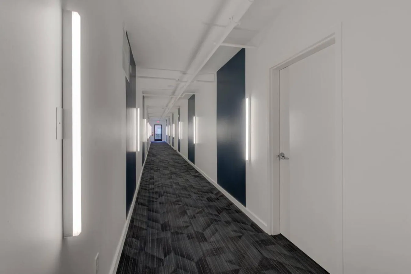 Zona común: Un largo pasillo interior con puertas a ambos lados.