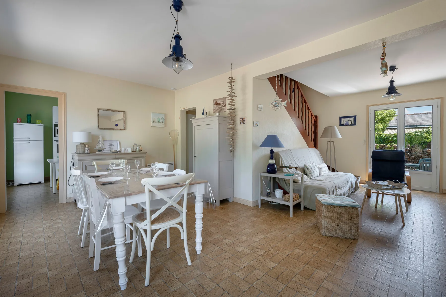A combined dining and living room with a long table and seating area.