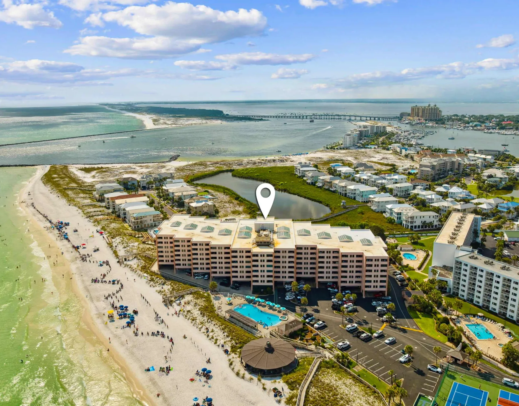 Zona común: Vista aérea de edificios junto a la playa y una piscina junto a la costa.