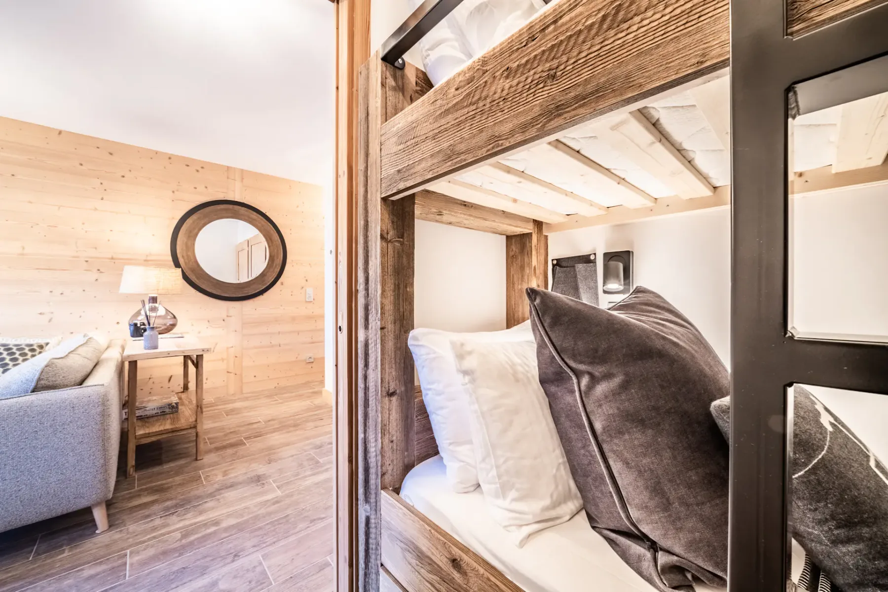 A wood-paneled bedroom with a bed and a small seating area.