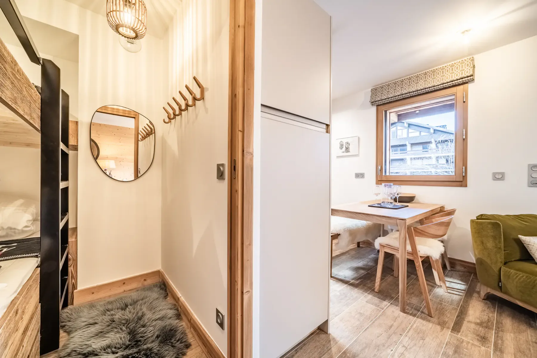 A bright dining nook with a wooden table beside a window.