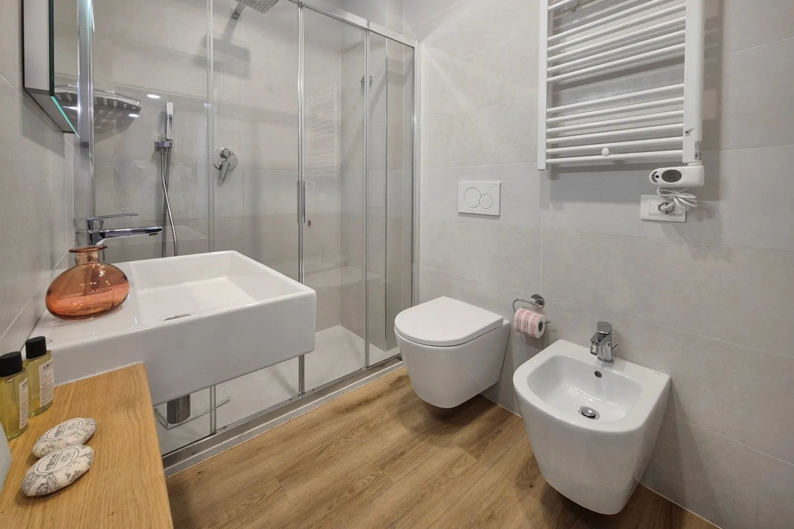 Representative hotel space: Bathroom with a glass shower, sink, toilet, and bidet.