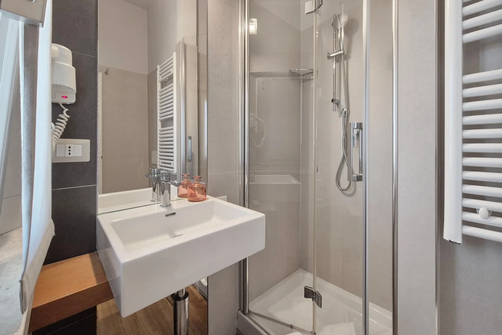 Representative hotel space: A bathroom with a sink and a glass-enclosed shower.