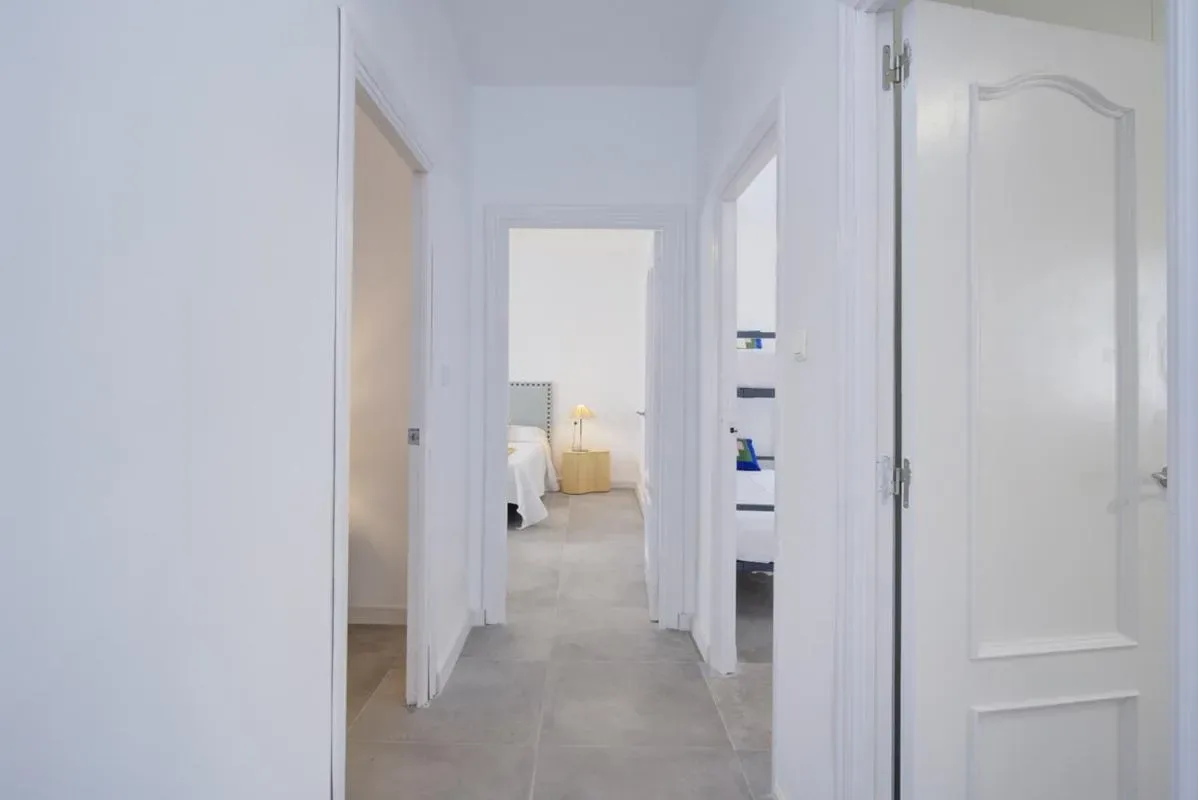 A bright interior hallway opens onto adjoining rooms.