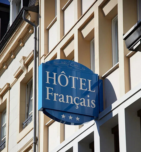 Representative hotel space: A hotel sign hangs on the exterior of a multi-story building.