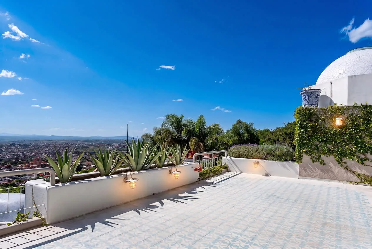 Shared amenity: A sunny rooftop terrace overlooks a wide cityscape.