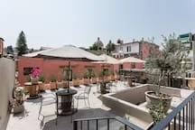 Shared amenity: Outdoor patio seating surrounds a raised central planter.