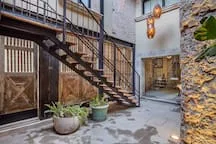 Shared amenity: An outdoor courtyard features a metal staircase and potted plants.