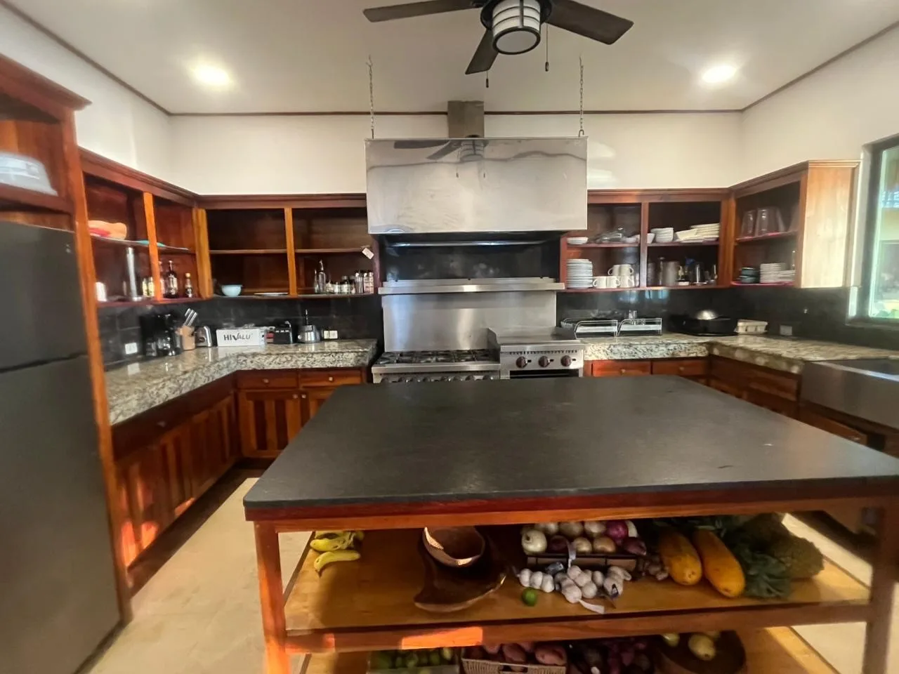 A spacious kitchen with wooden cabinets and a large central island.