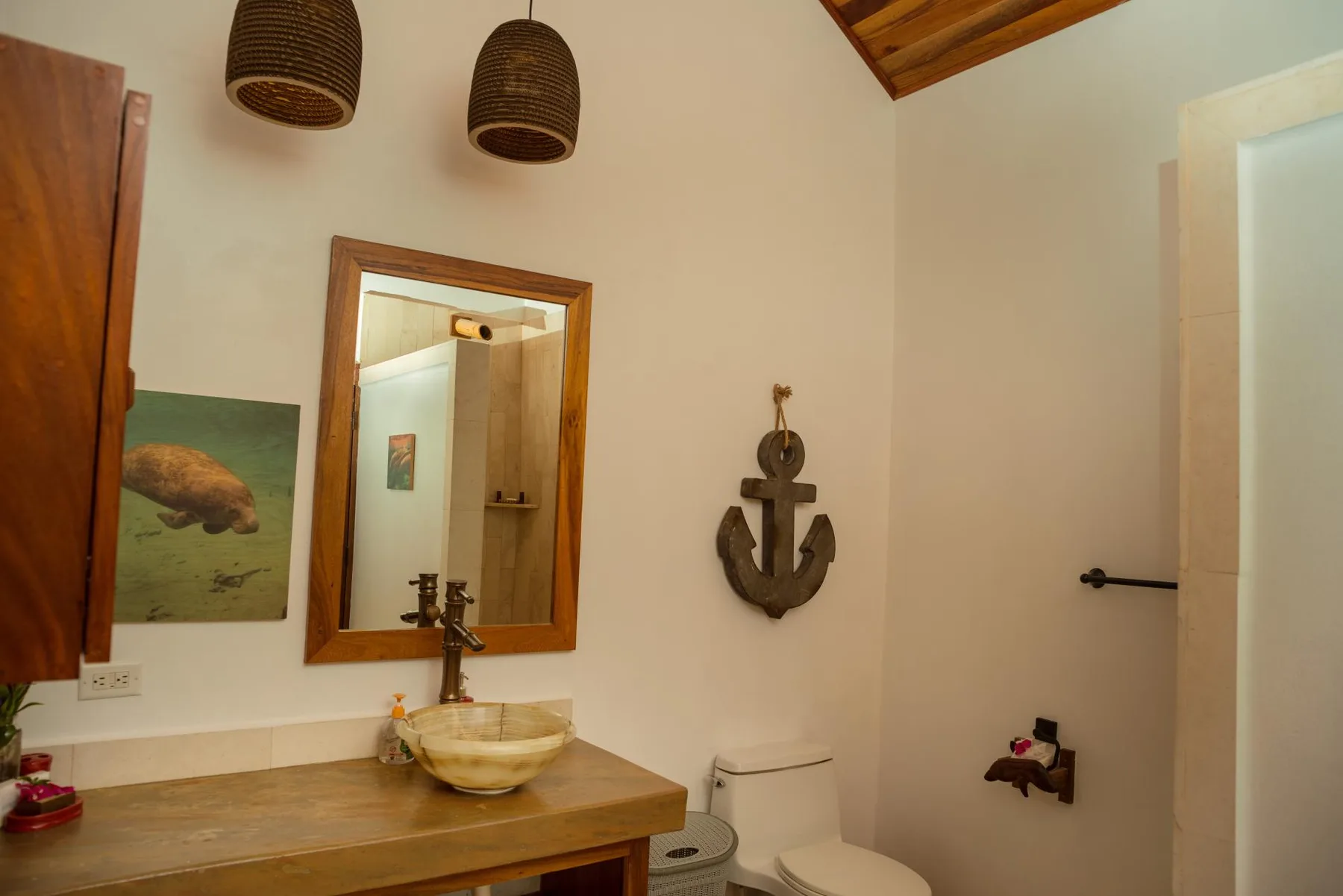 A bathroom with a sink, toilet, and shower area.