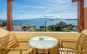 Representative hotel space: A balcony seating area overlooks the sea and distant islands.