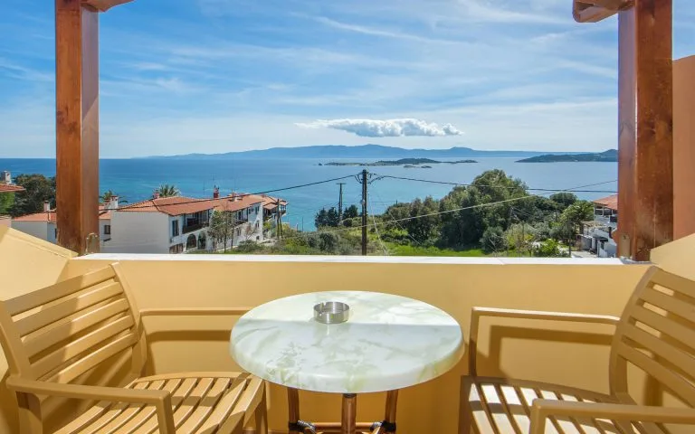Representative hotel space: A balcony seating area overlooks the sea and distant islands.