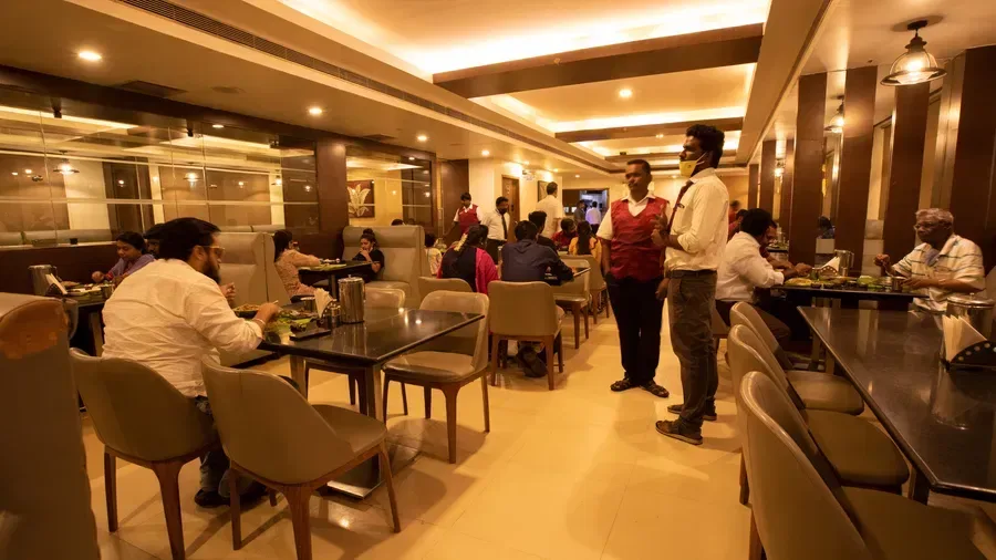 Representative hotel space: A restaurant dining area with seated guests and staff.