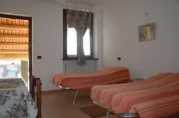 Representative hotel space: A room with seating, a window, and a bed.