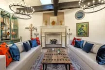A living room with facing seating and a fireplace.