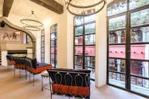 A bright dining area with tables and tall black-framed windows.