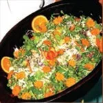 Representative hotel space: A black pan holds a colorful dish topped with herbs and citrus slices.