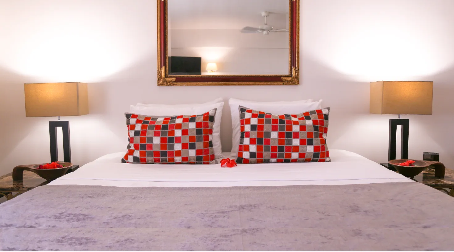 Representative hotel space: A bedroom with a neatly made bed and patterned pillows.