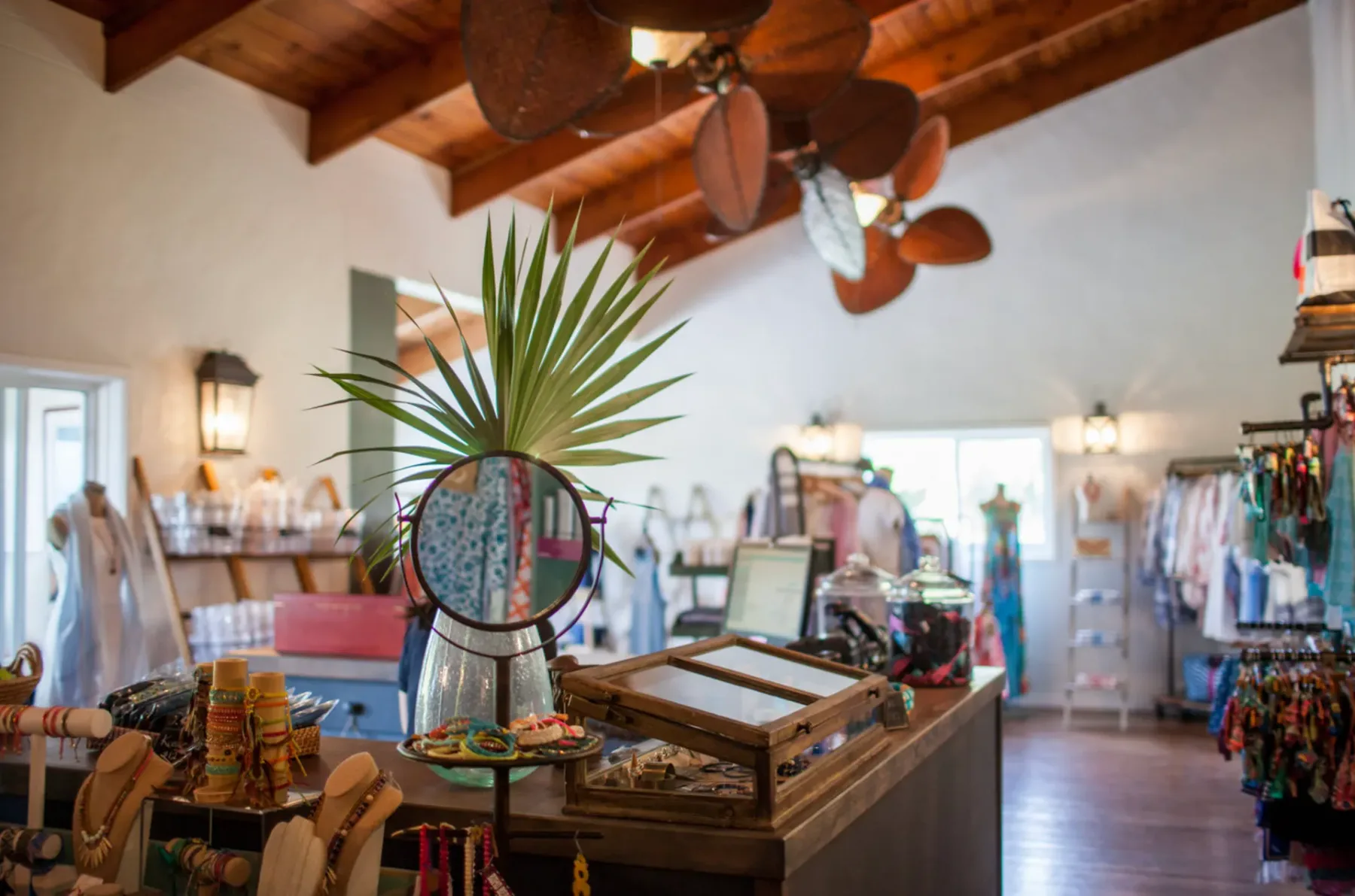 Representative hotel space: A shop interior with display tables and clothing racks.