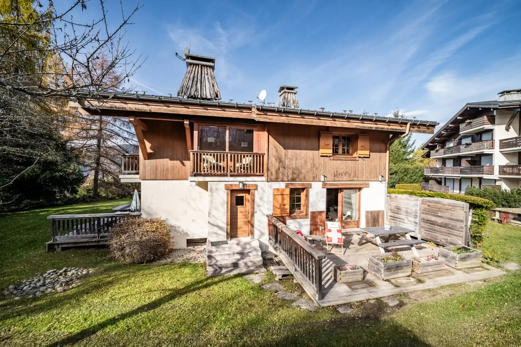 Shared amenity: A chalet-style building with a small patio and lawn.