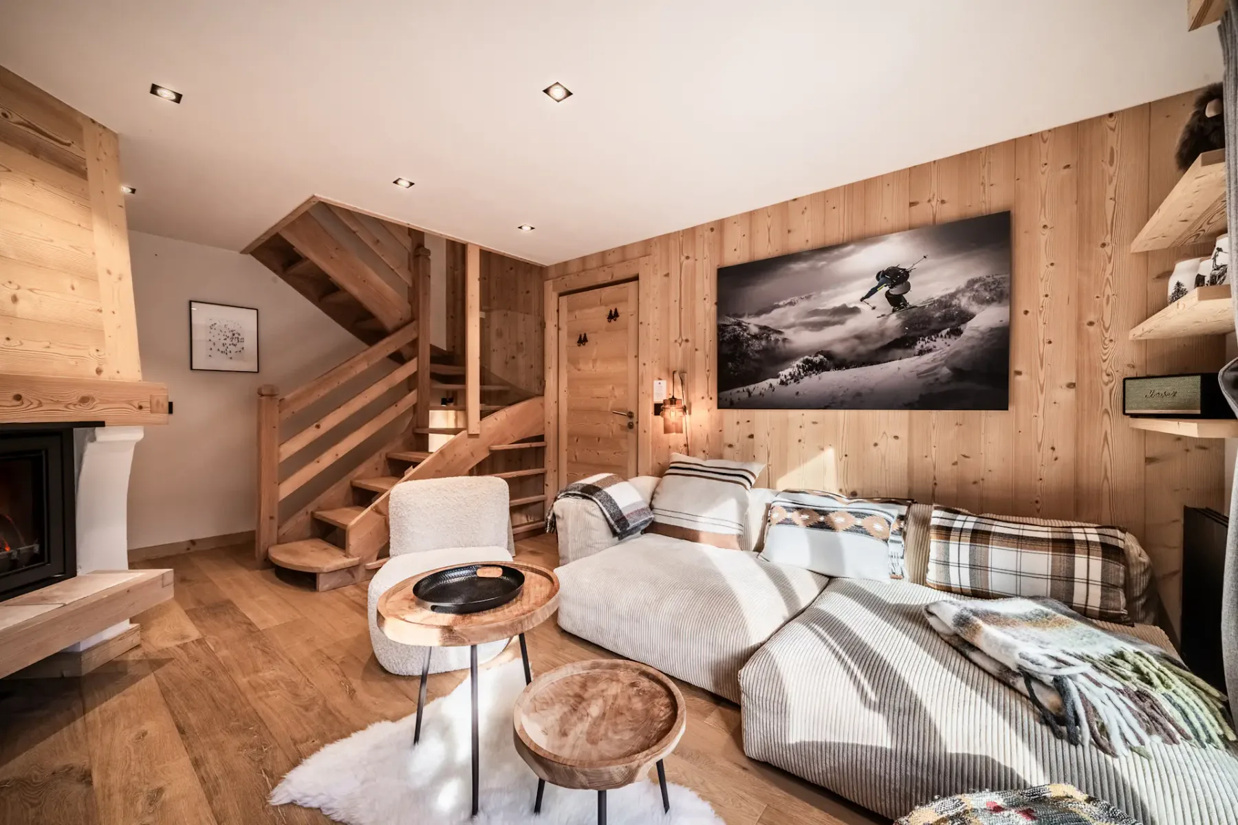 A wood-paneled living room with seating arranged around a low coffee table.