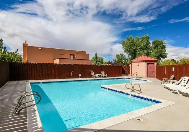 Shared amenity: An outdoor swimming pool with lounge chairs and a small poolside structure.