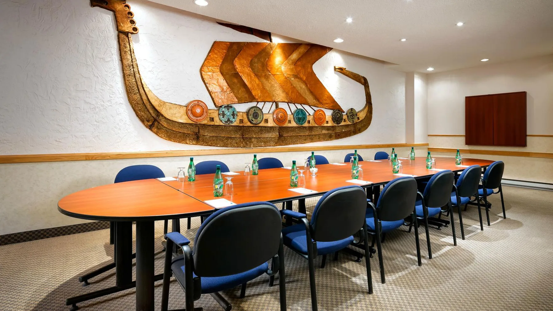 Representative hotel space: A conference room with a long table surrounded by chairs and a wall mural.