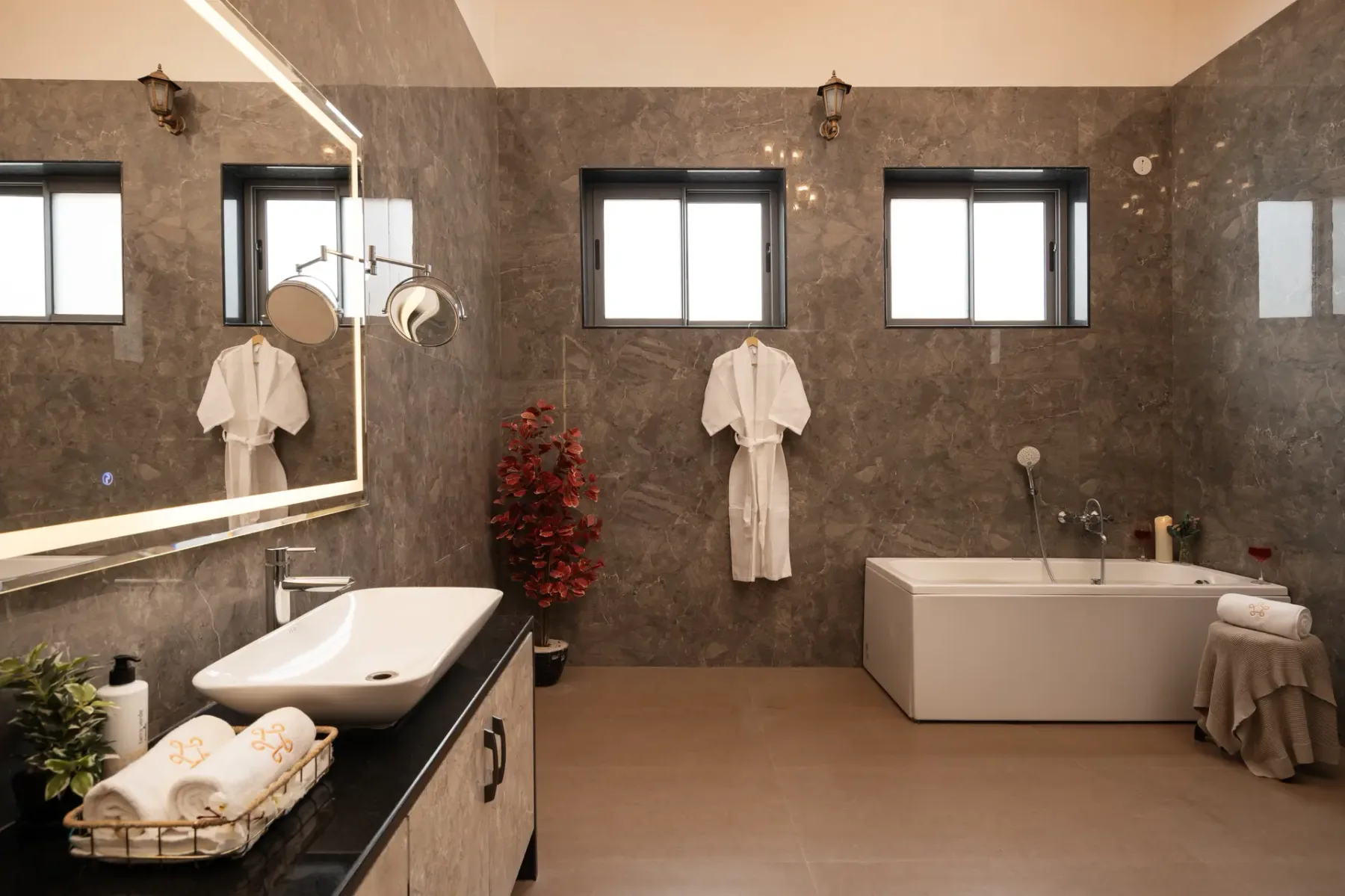A bathroom with a bathtub, sink, and wall mirror.