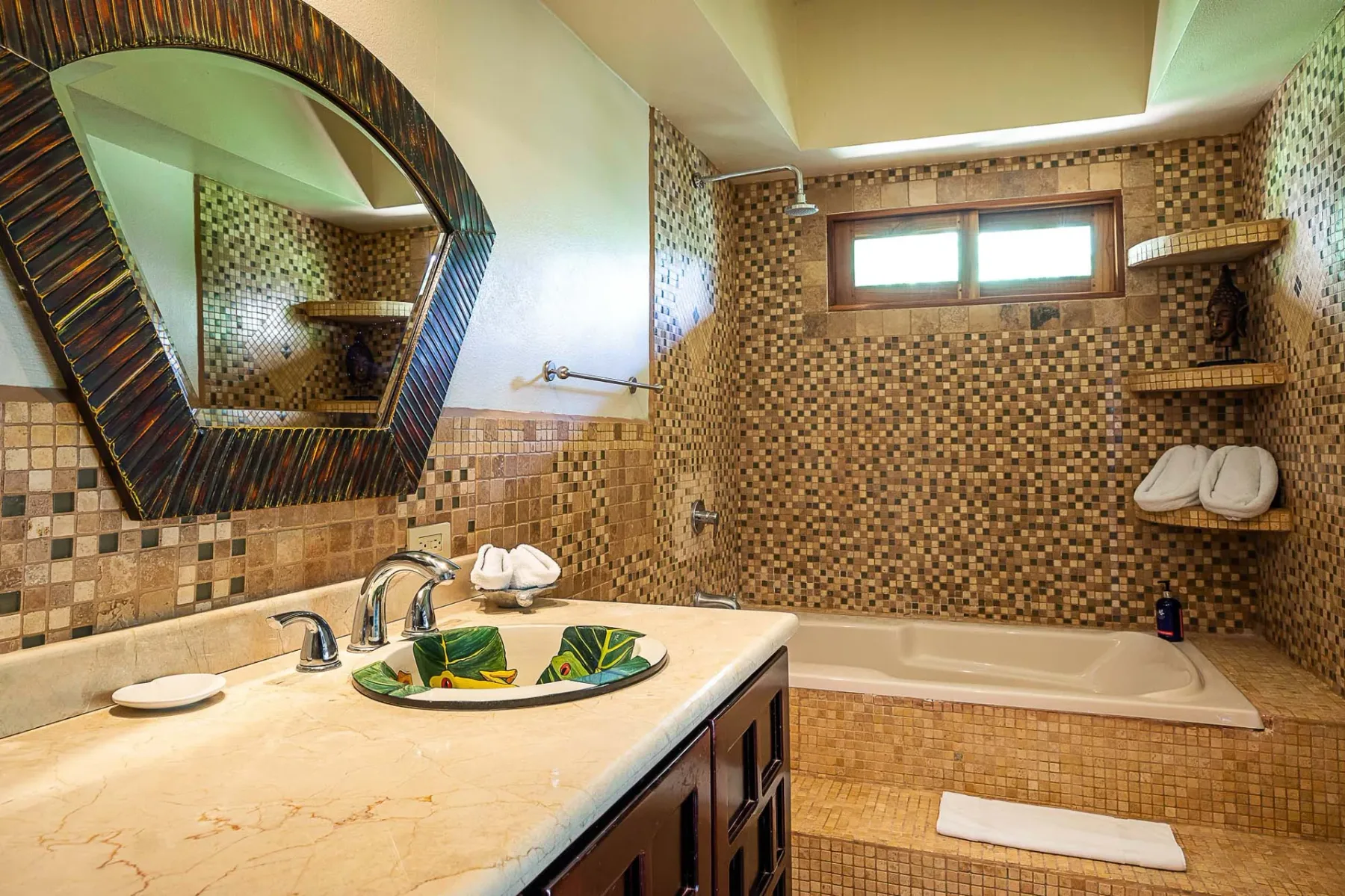A tiled bathroom has a bathtub, shower, and a vanity with a decorative sink.