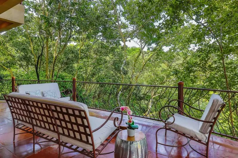 Casa Estrella del Mar · 23. A private terrace features comfortable outdoor seating and expansive views into the surrounding Costa Rican rainforest.