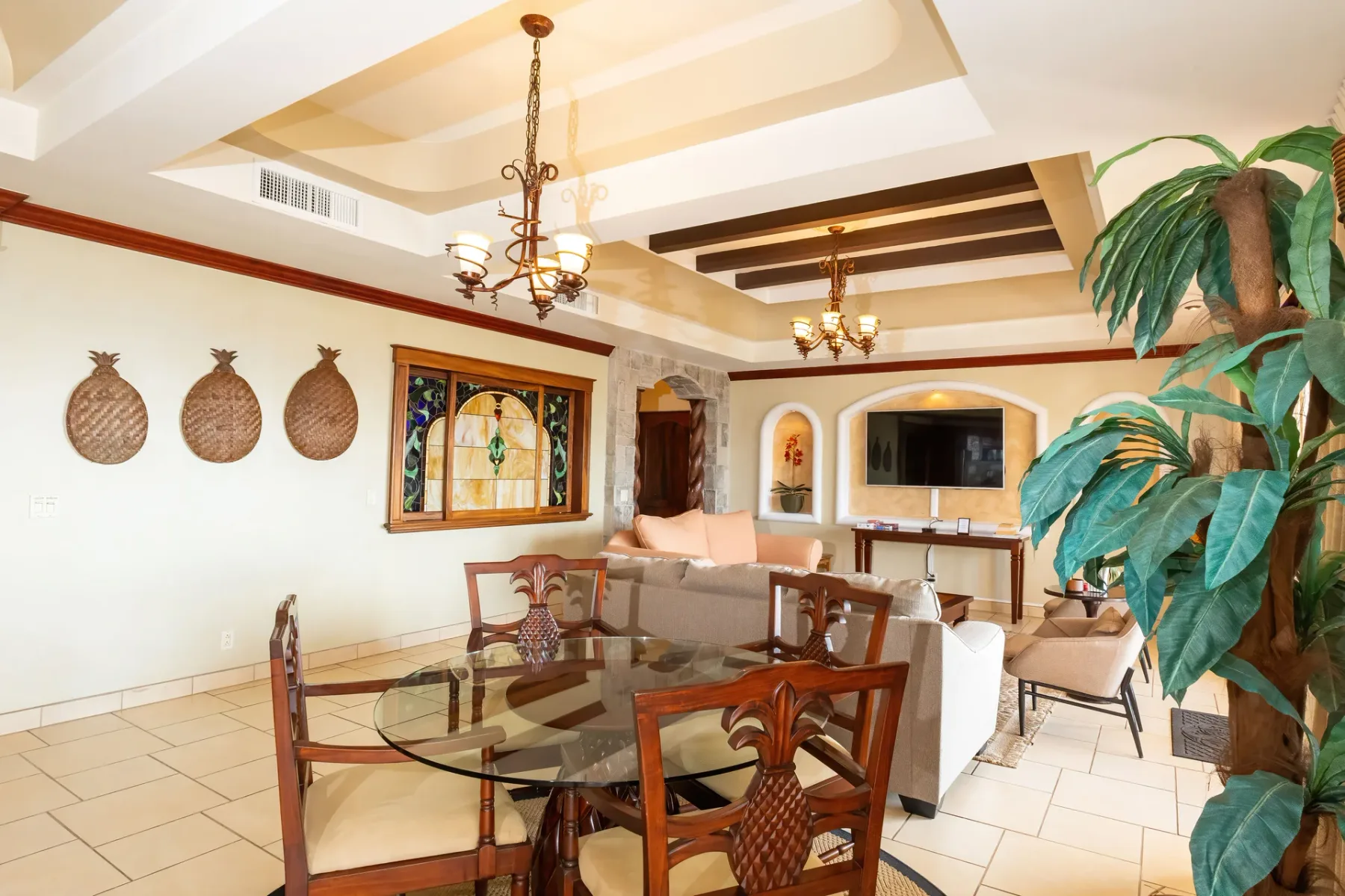 A living and dining area with a glass table and seating.
