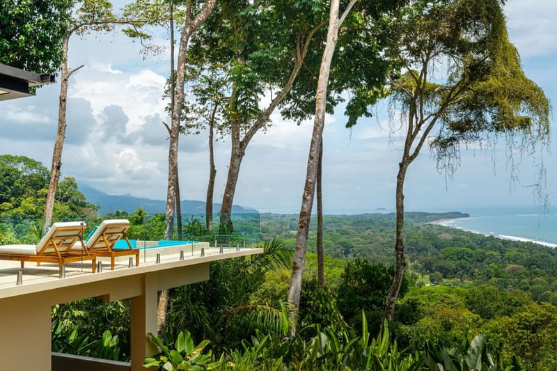 Casa La Vista · 17. The infinity pool and lounging terrace overlook an expansive view of the coastline, tropical forest, and ocean.