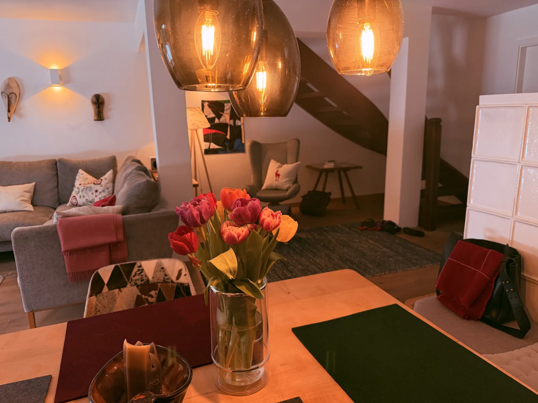 A living and dining area with seating and pendant lights.