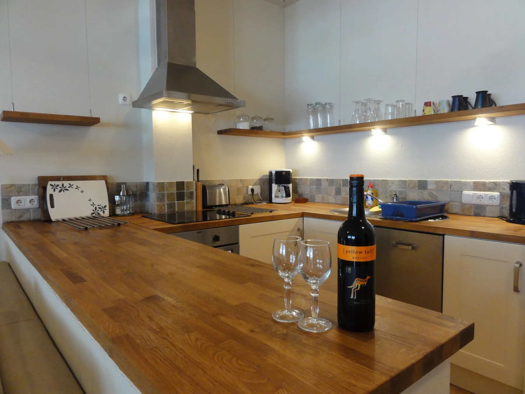 A kitchen with wooden countertops and a central island.