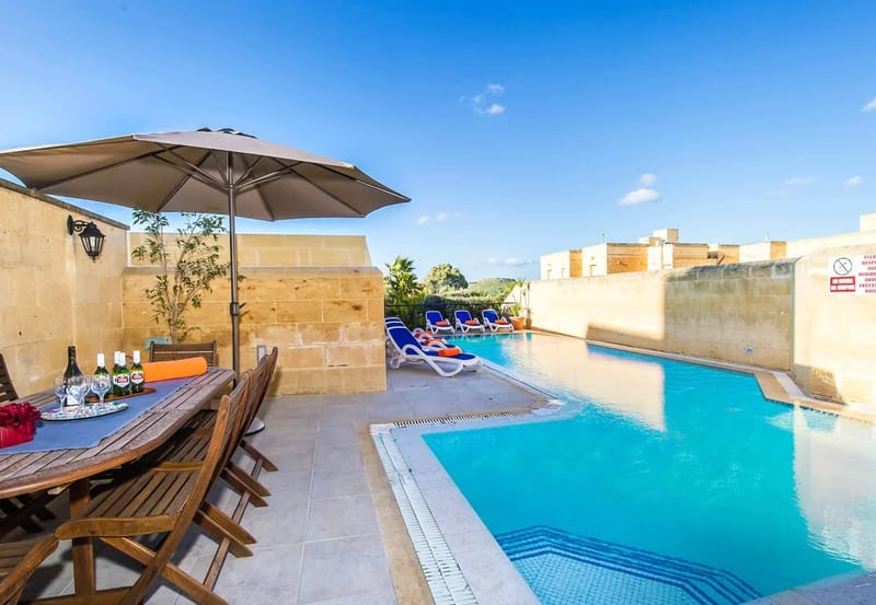 Zona de piscina de la villa vacacional Four Winds en Gozo