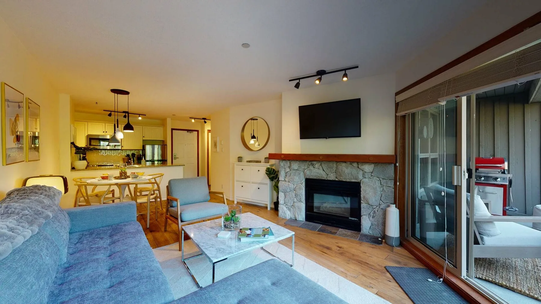 A living area with seating, a fireplace, and sliding glass doors.