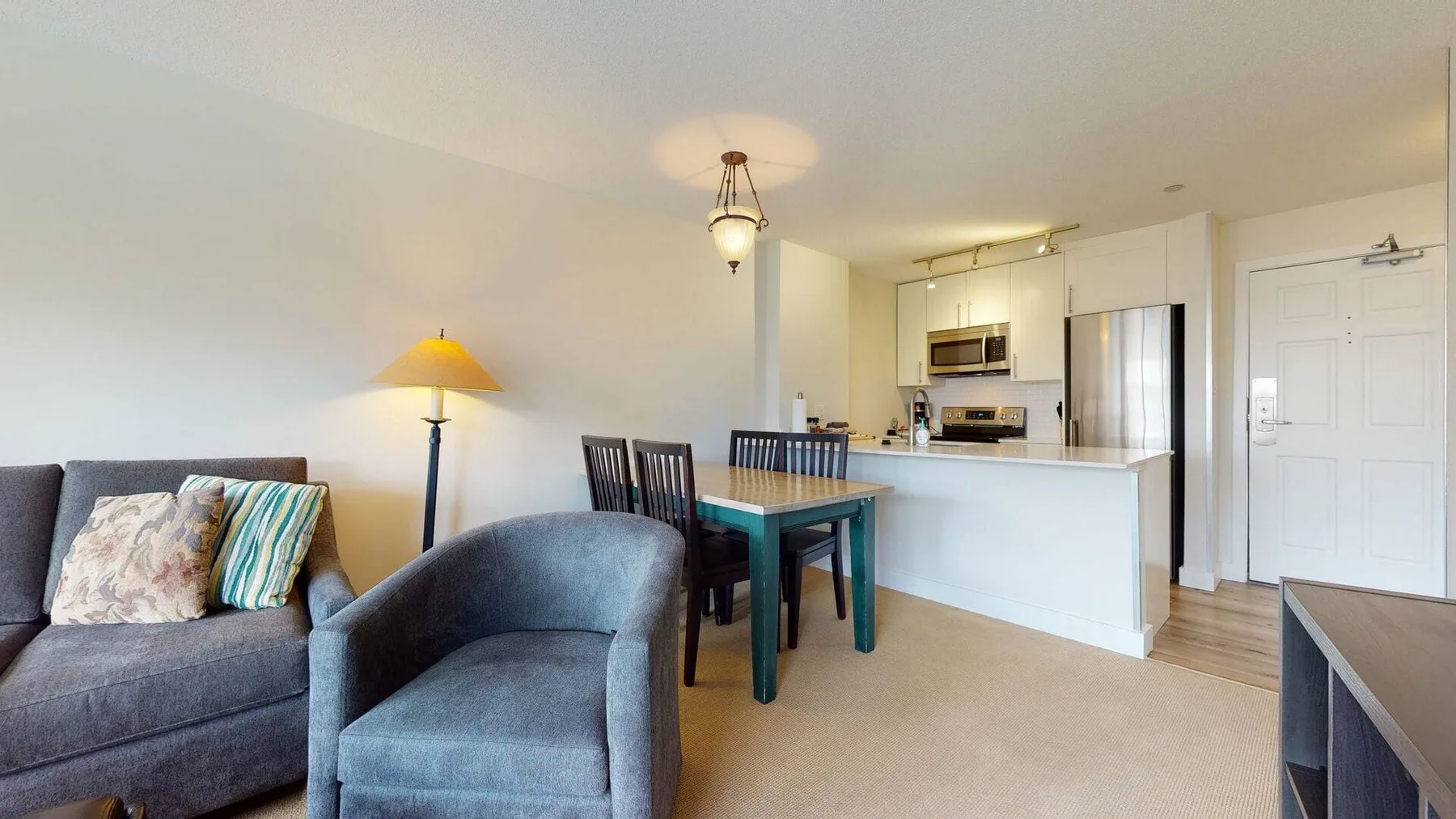 An open-plan living and dining area with a kitchen and dining table.