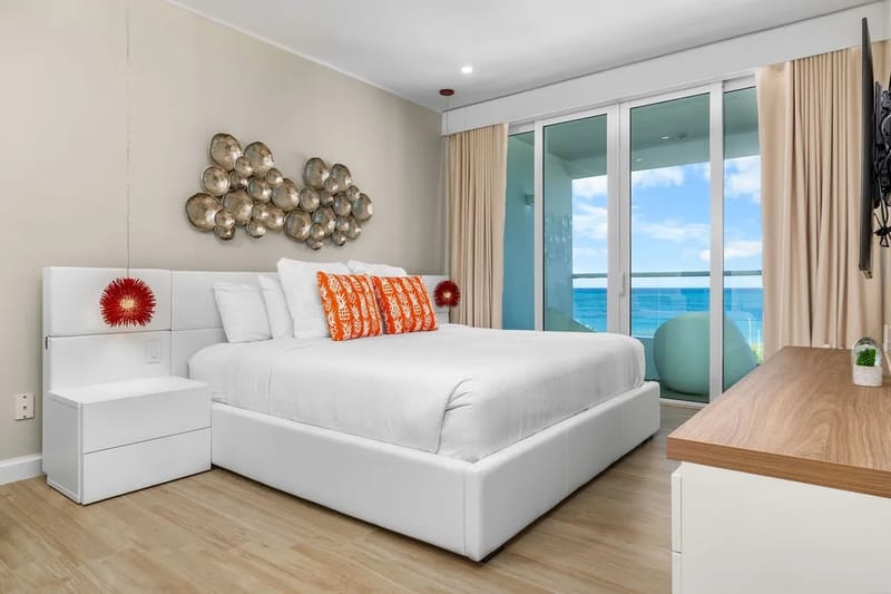 Wake up to breathtaking ocean views through floor-to-ceiling windows. Your stylish retreat features crisp white linens, modern décor, and a peaceful ambiance perfect for unwinding.