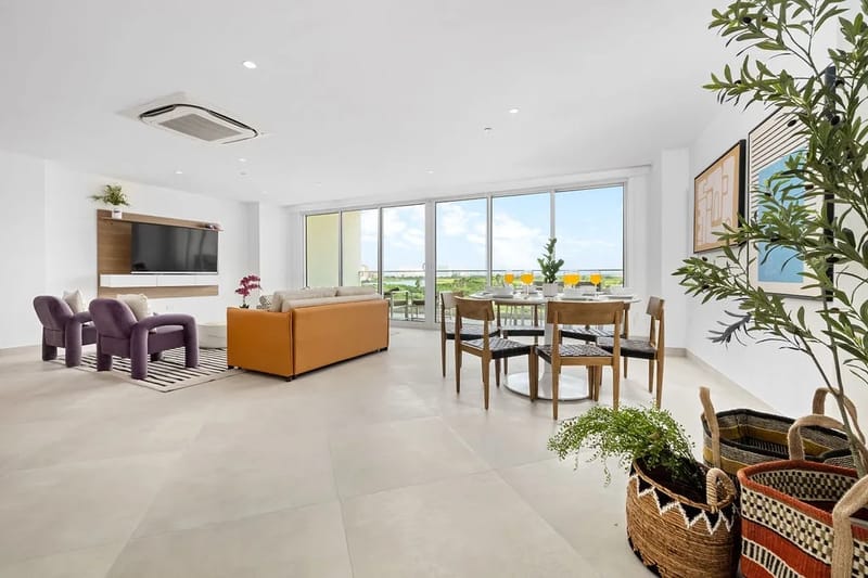 Bright, airy living space with floor-to-ceiling windows and a private balcony.