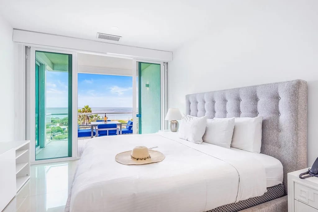 Wake up to ocean breezes and sparkling sea views through your private balcony doors. Crisp linens and coastal light create your perfect beach retreat.