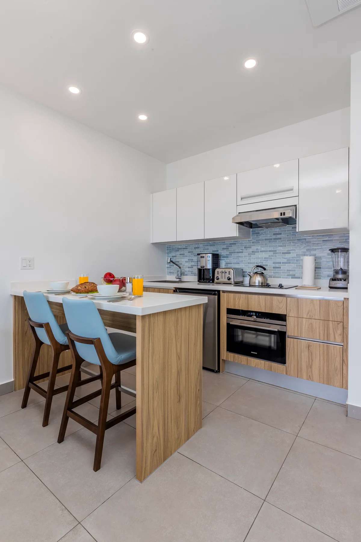 Step into your fully-equipped kitchen with modern appliances, sleek countertops, and a breakfast bar—perfect for casual meals and morning coffee before your day begins.