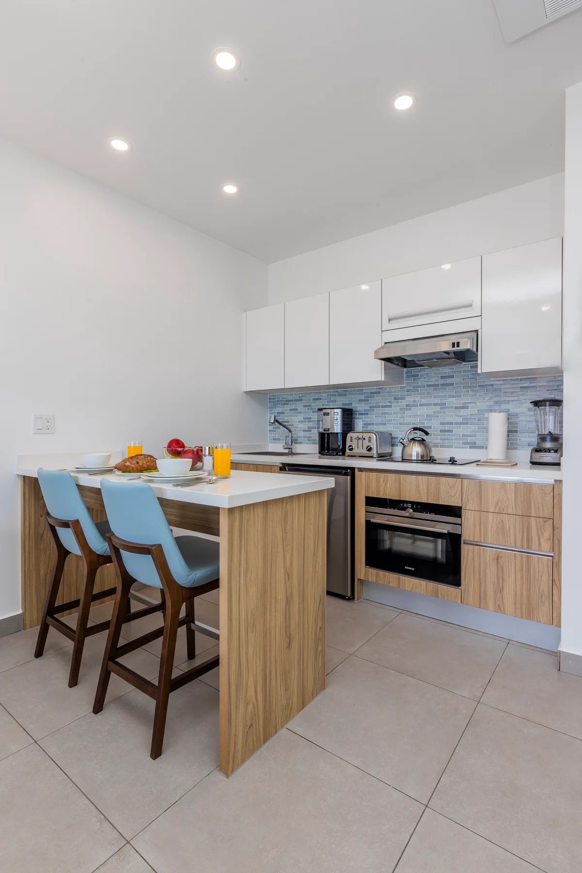 Step into your fully-equipped kitchen with modern appliances, sleek countertops, and a breakfast bar—perfect for casual meals and morning coffee before your day begins.