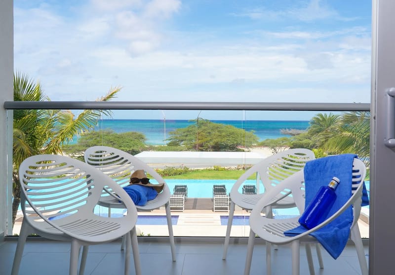 Relax on your private balcony and take in breathtaking ocean views while overlooking the sparkling pool below.