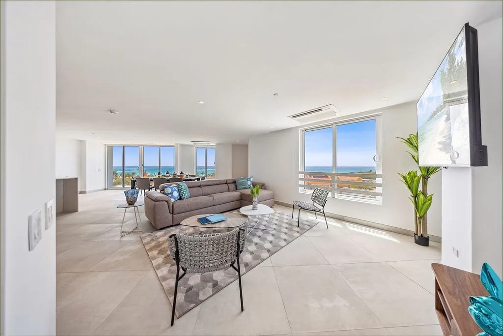 Bright, open living space with floor-to-ceiling windows and ocean views.