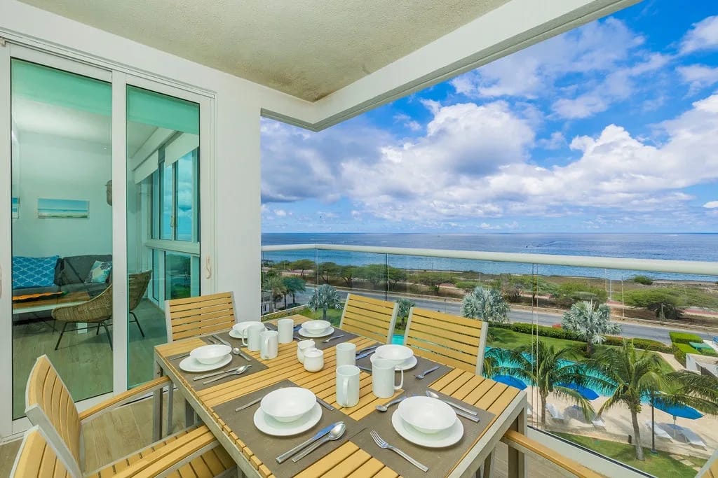 Private balcony table with sweeping ocean views and tropical breezes.