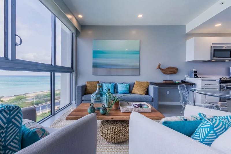 Espacio de estar luminoso, inspirado en la playa, con vistas a la costa.