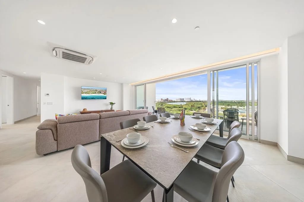Open living and dining area with expansive windows and natural views.